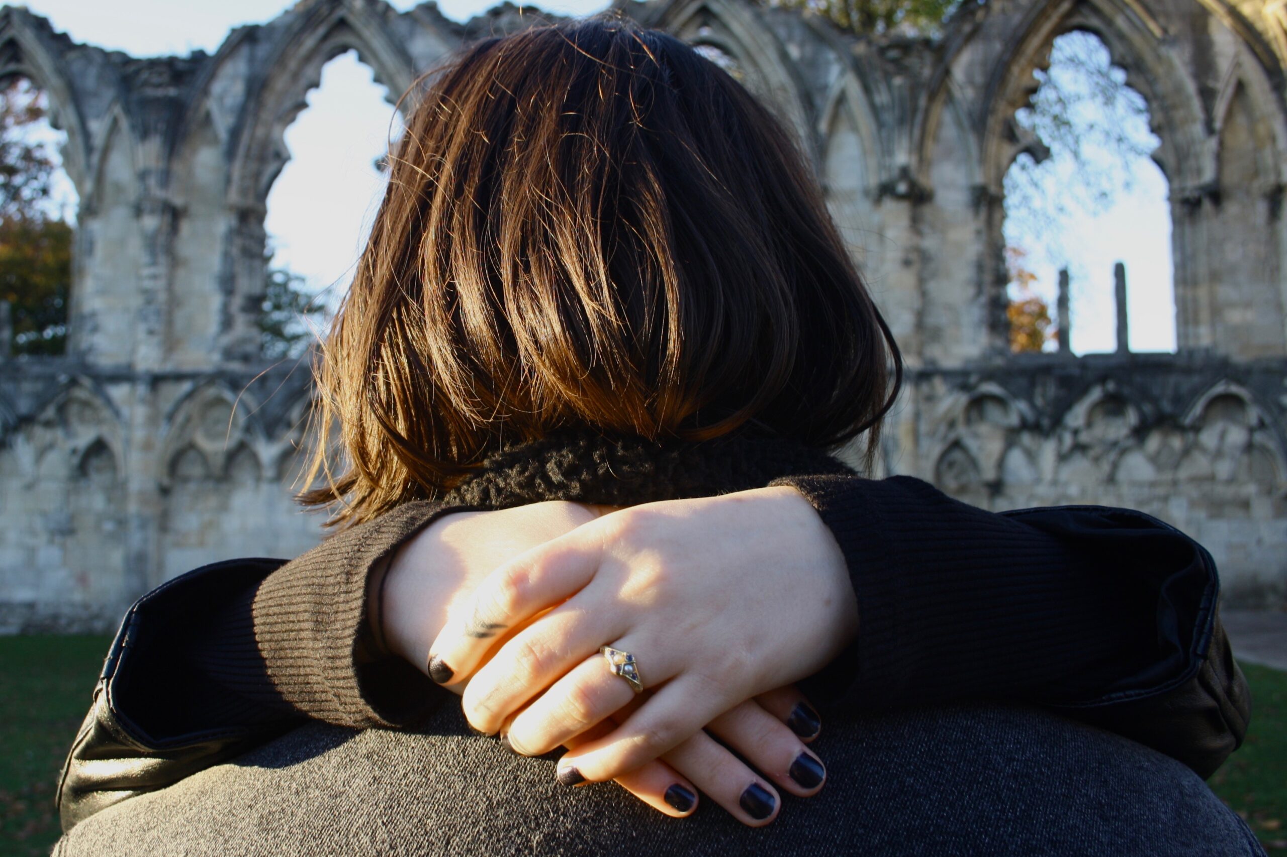 Woman and man embracing with architectural backdrop