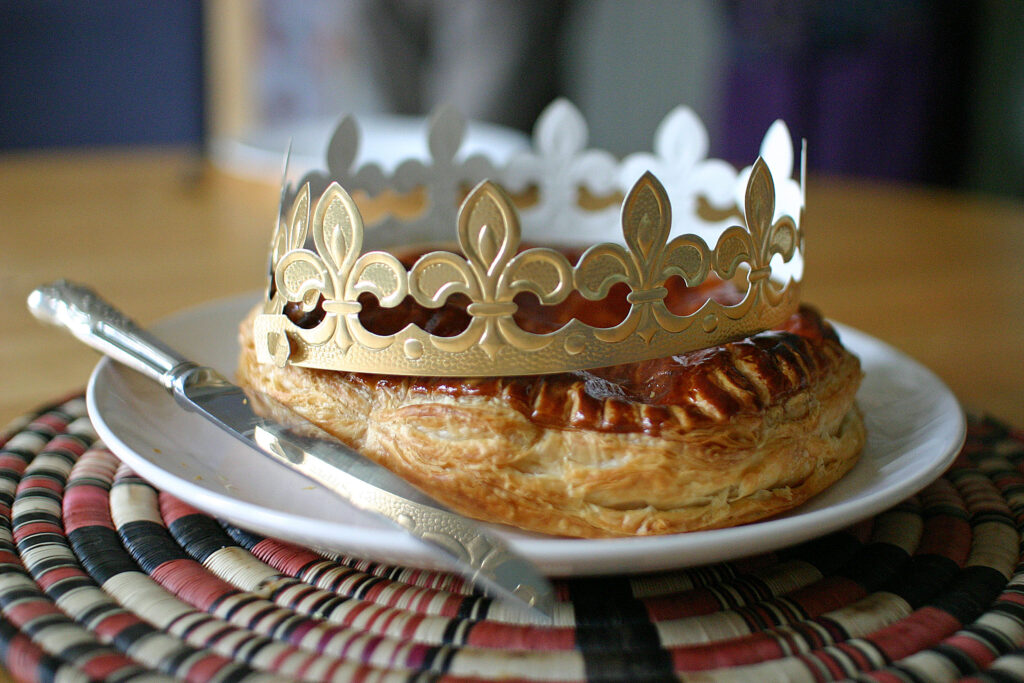 galette des rois, a round puff pastry cake with paper crown on top